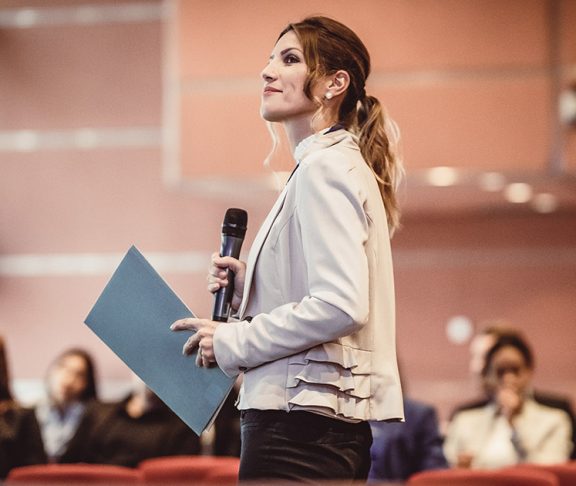 A woman leading a conference