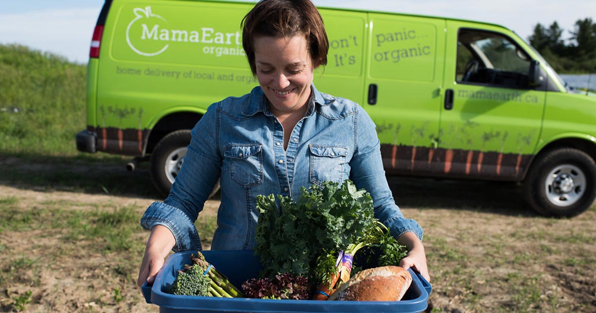 Mama Earth worker smiling with vegetables