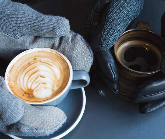 Gloved hands holding lattes