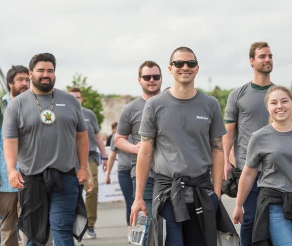 Group of people walking in Nutrien shirts