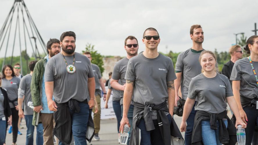 Group of people walking in Nutrien shirts