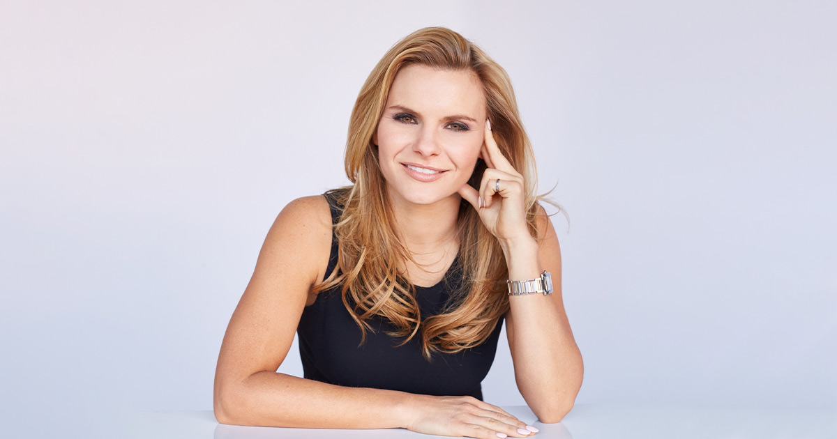 Michele Romanow leaning her elbows on a surface