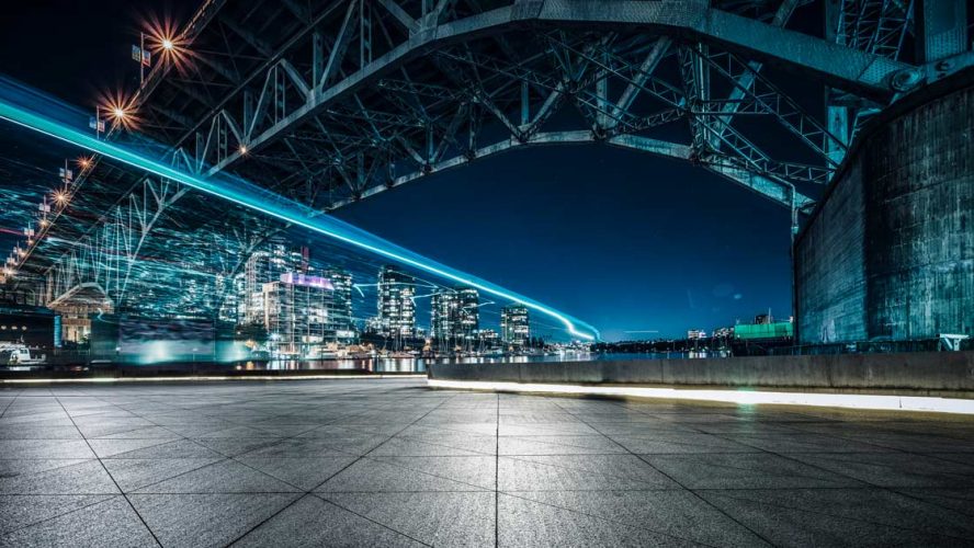 Long exposure of lights under a bridge at night