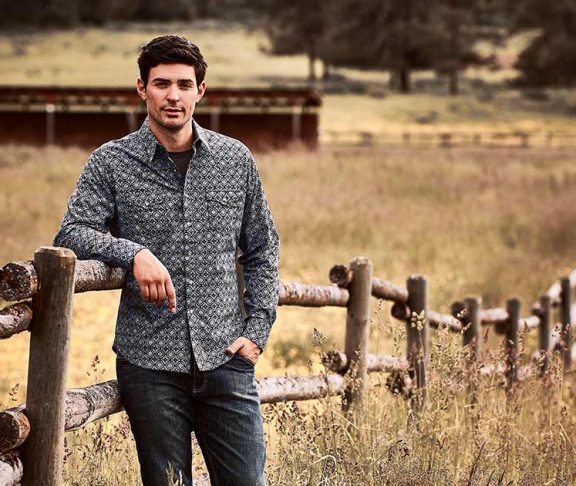 Carey Price leaning on a fence in a field