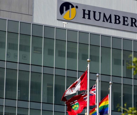 Humber College building with Canadian, Ontario, and Pride flags