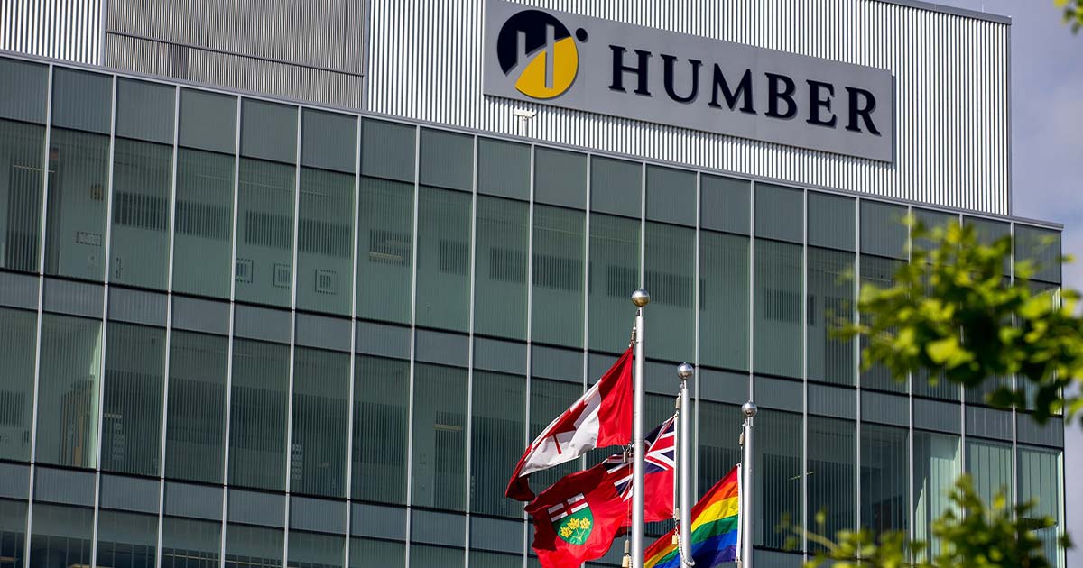 Humber College building with Canadian, Ontario, and Pride flags