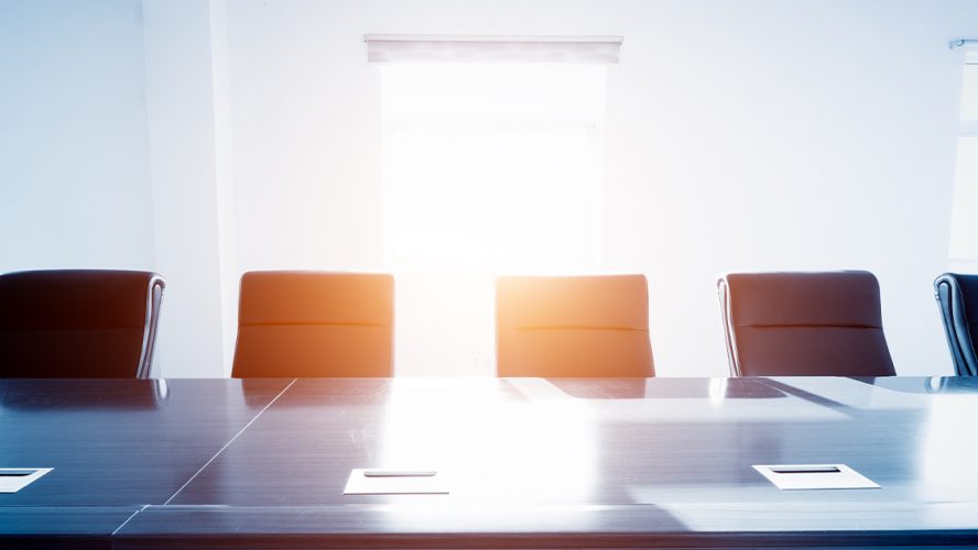 Empty chairs in a corporate board room