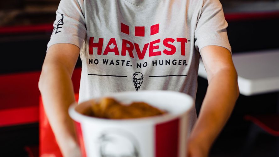 KFC Harvest volunteer holding a bucket of chicken