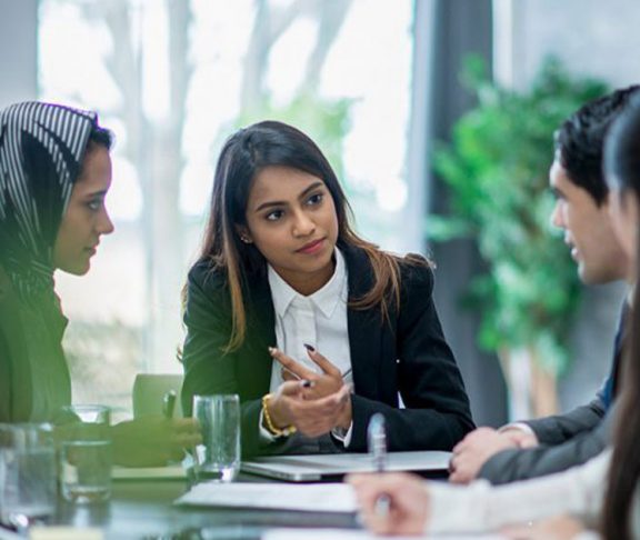Woman leading a diverse business meeting