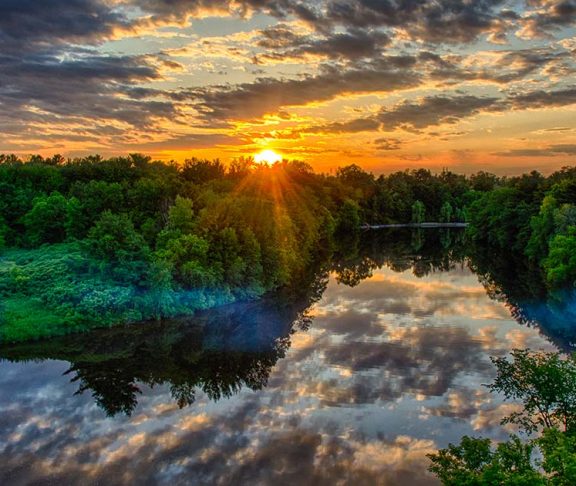sunset over rideau river natural climate solutions