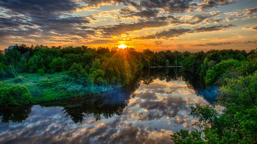 sunset over rideau river natural climate solutions
