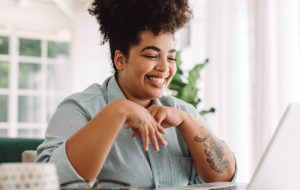 african american woman smiling looking at computer