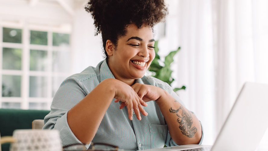 african american woman smiling looking at computer