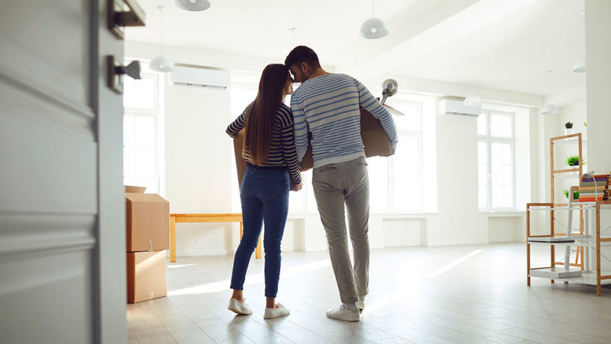 couple holding hands moving into new home