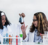women lab coat chemicals scwist