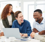 office workers of different races laughing