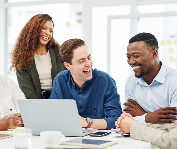 office workers of different races laughing