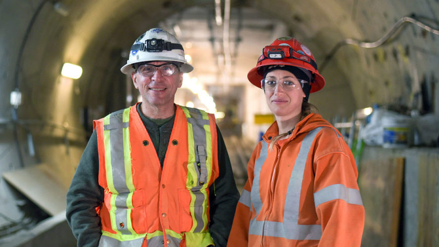 man and woman wearing safety vests and protective gear
