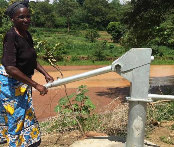 Woman making use of a water well