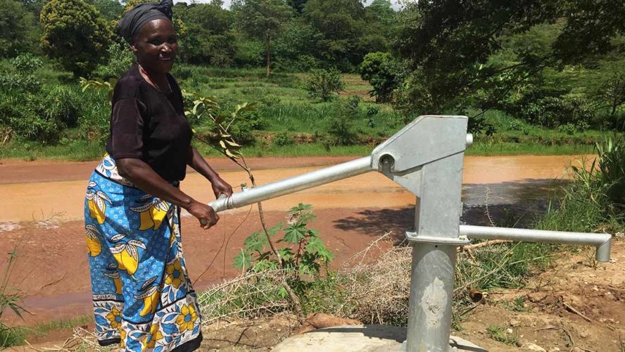 Woman making use of a water well