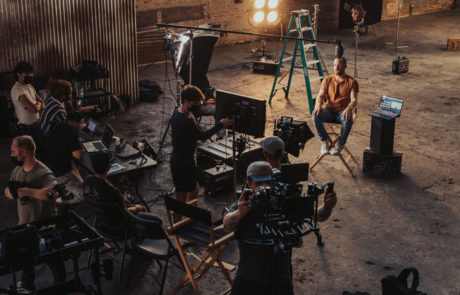 A film set and crew preparing for a shoot in a warehouse