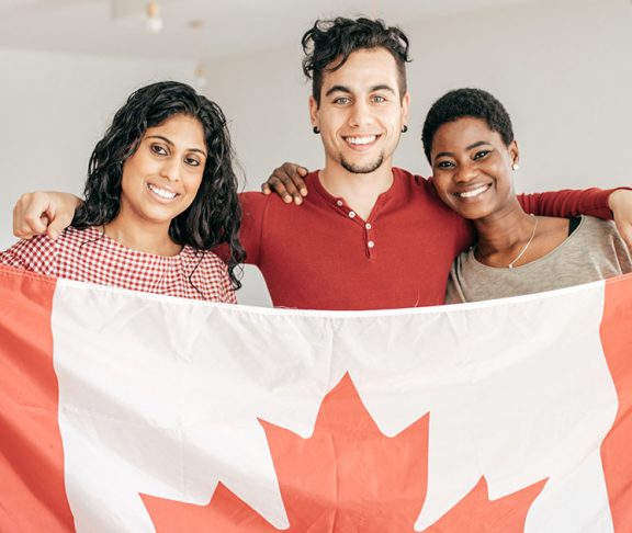 Three new Canadians holding a flag