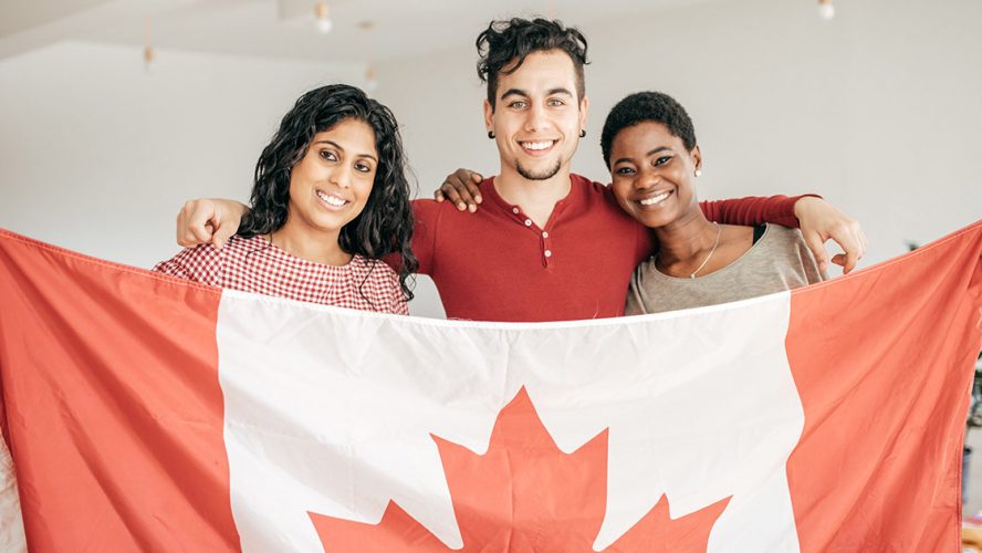 Three new Canadians holding a flag