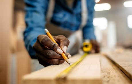 Carpenter marking measurements on wood