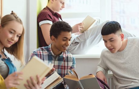 High school students reading books together