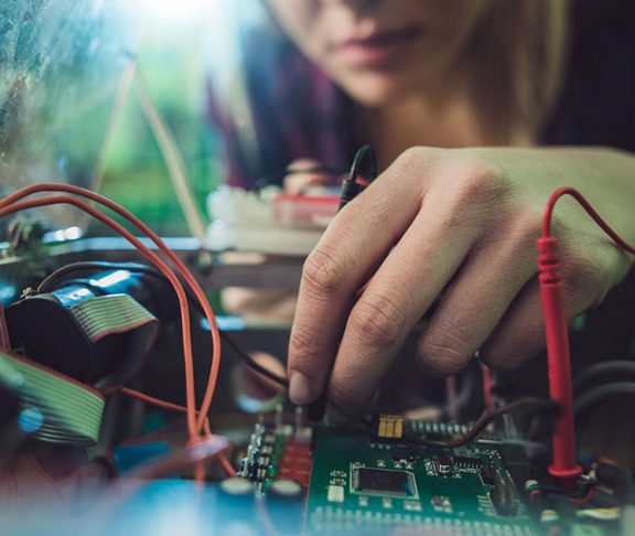 Woman working on a circuit board