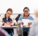 two female students in classroom nait