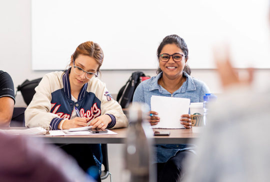 two female students in classroom nait