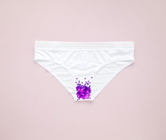 Woman white panties with glitter on pastel colorful background. Menstruation, woman's health, virginity, first sex. Conceptual minimal still life