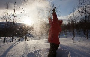 Barn kaster snø opp i luften