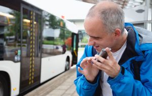 Blind-man-using-cellphone-at-bus-stop