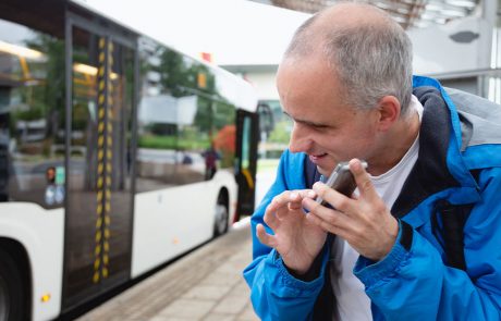 Blind-man-using-cellphone-at-bus-stop