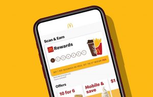 McDonald's app on a phone against a golden background