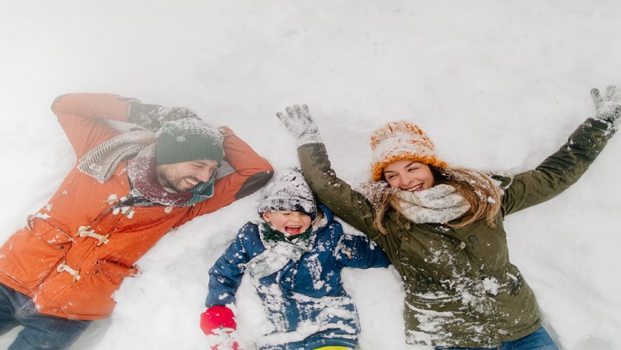 Family of Three Playing in Snow