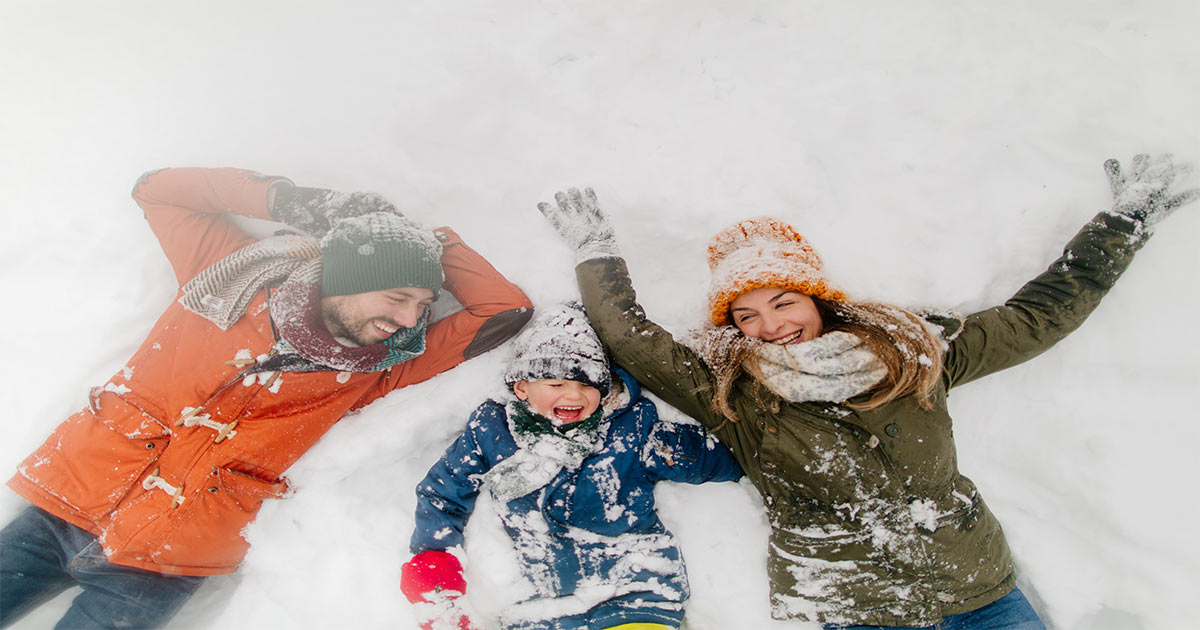 Family of Three Playing in Snow