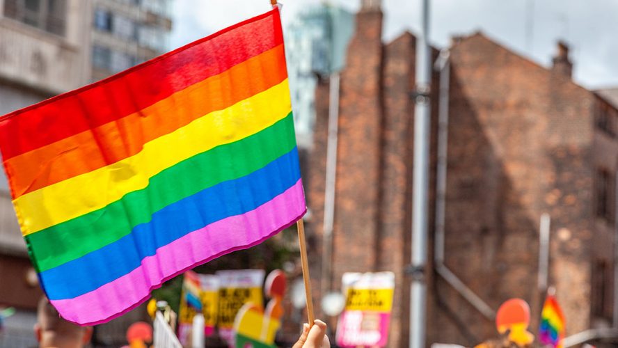 Waving a rainbow flag at a Pride Parade