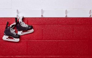hockey skates over red wall