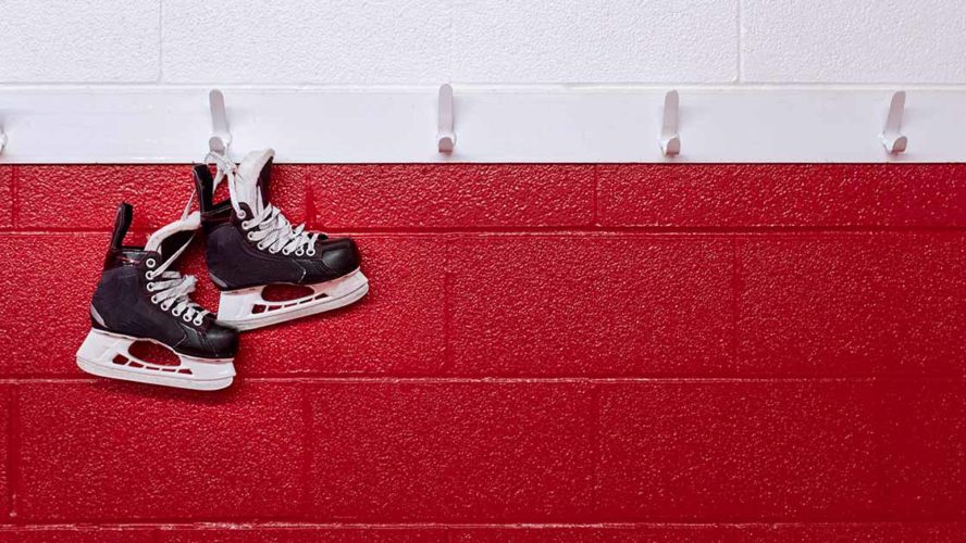 hockey skates over red wall