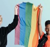 two people holding pride flag