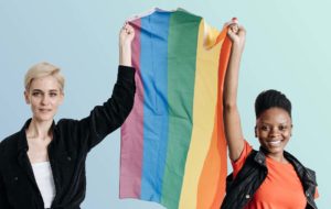two people holding pride flag