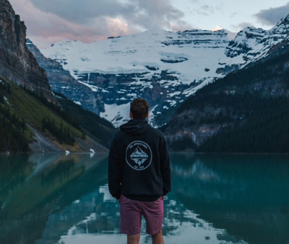 man standing in front of lake louise