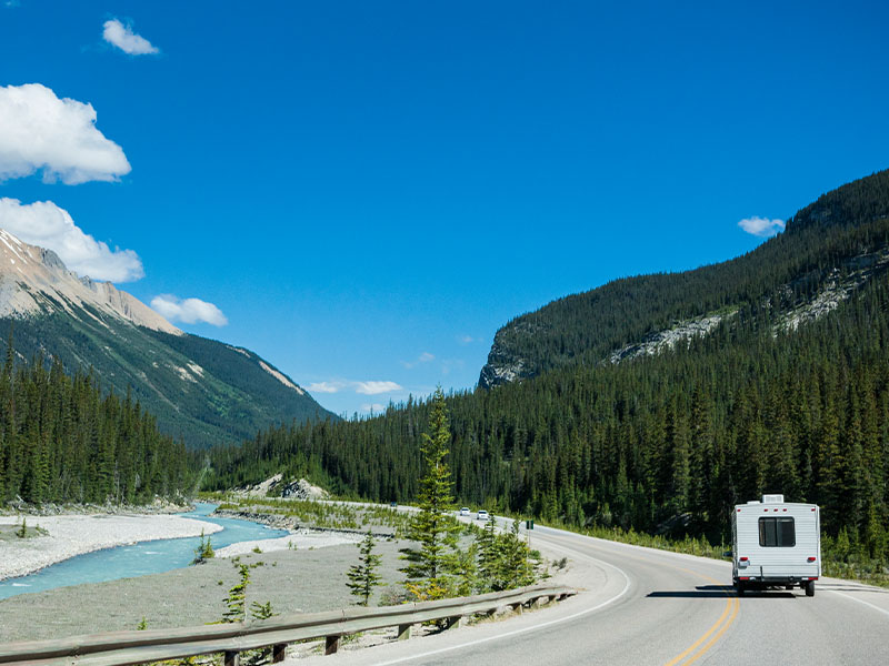 RV driving down highway in Banff