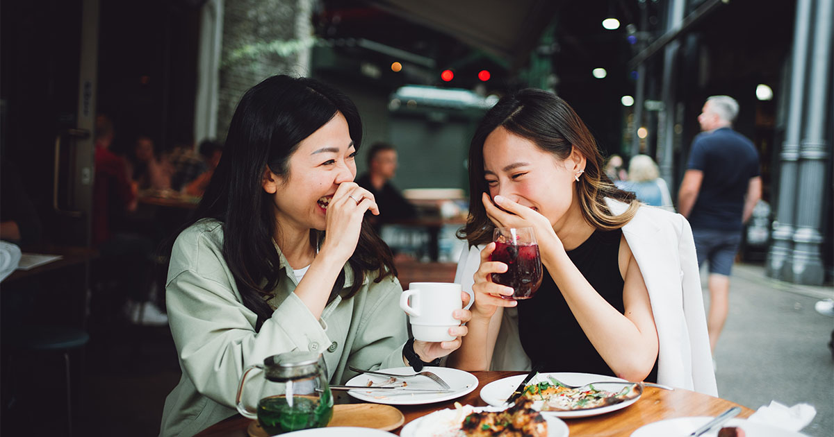 two asian women laughing