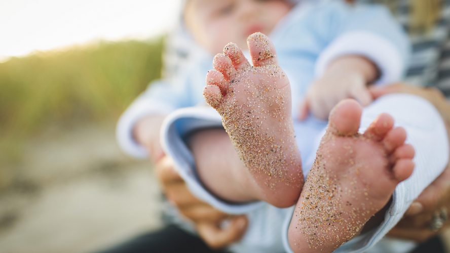 stopy dziecka ubrudzone piaskiem