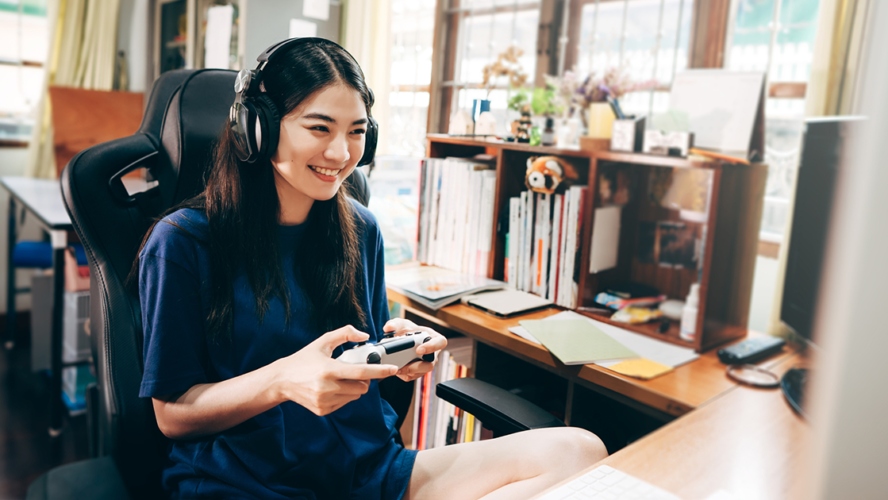 Young adult woman hand holding a joy controller wear headset and play game.