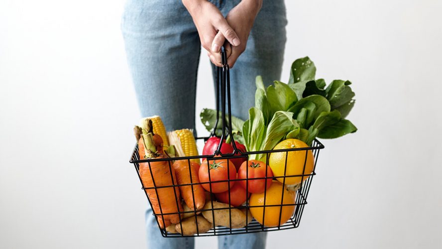 kvinde holder kurv med madvare der kan indgå i en vegetar diæt